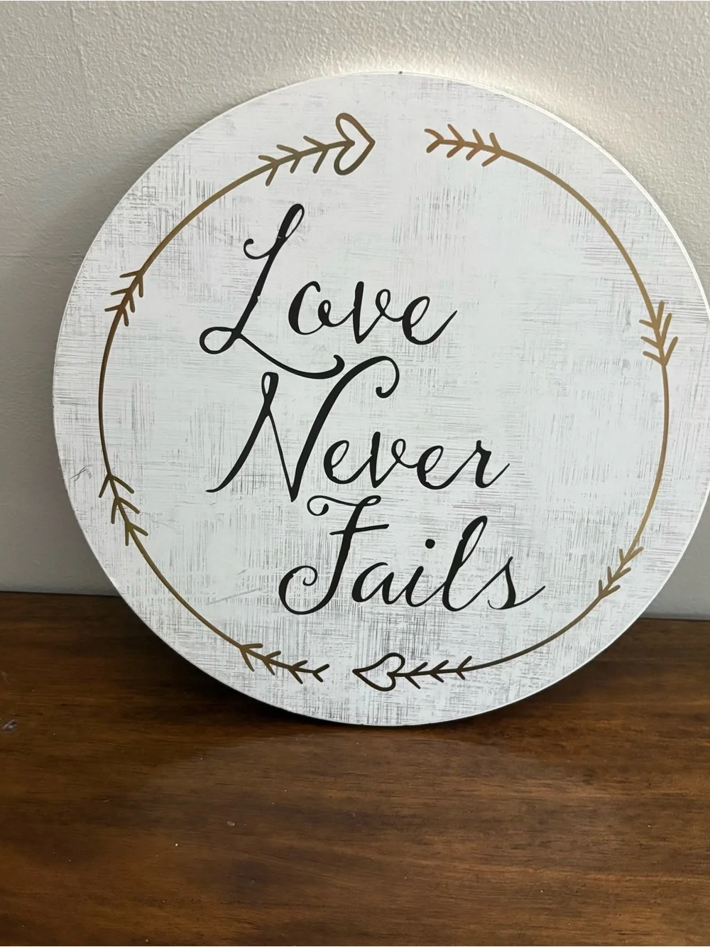 Love Never Fails Round Wall Sign - White with Black Script 12” home decor